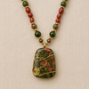 Forest Bloom handcrafted necklace close-up featuring a polished Unakite pendant wrapped in gold-tone wire with Kambaba Jasper, Red Malaysian Jade, and gold accent spacers by Stone & Story Jewelry.