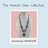 Polaroid-style graphic featuring the Serenely Amethyst Necklace on a linen display. Text reads 'The Moonlit Glow Collection' and 'Serenely Amethyst' against a soft blue background. Promotional image for the Moonlit Glow Collection by Stone & Story Jewelry.