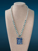 Ocean Current Necklace on mannequin with branded blue background.