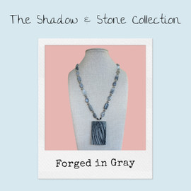 Polaroid-style product card for Forged in Gray necklace — part of the Shadow and Stone Collection by Stone & Story Jewelry, presented on soft pastel background.