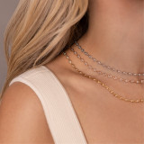 woman's neck showing three pear tennis necklaces in white, rose and yellow gold