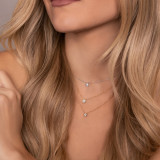 Woman wearing three honeycomb diamond solitare necklaces