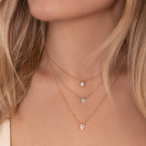 Neck wearing three stacked diamond hexagon pendant necklaces