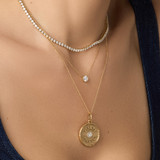 Lifestyle image of lady wearing Large Porte Bonheur Diamond and Gold Pendant