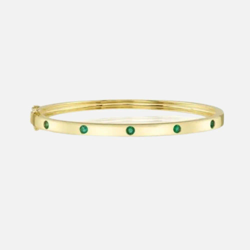 Yellow Gold and Emerald Bracelet: This gold bangle incorporates emeralds along its length.