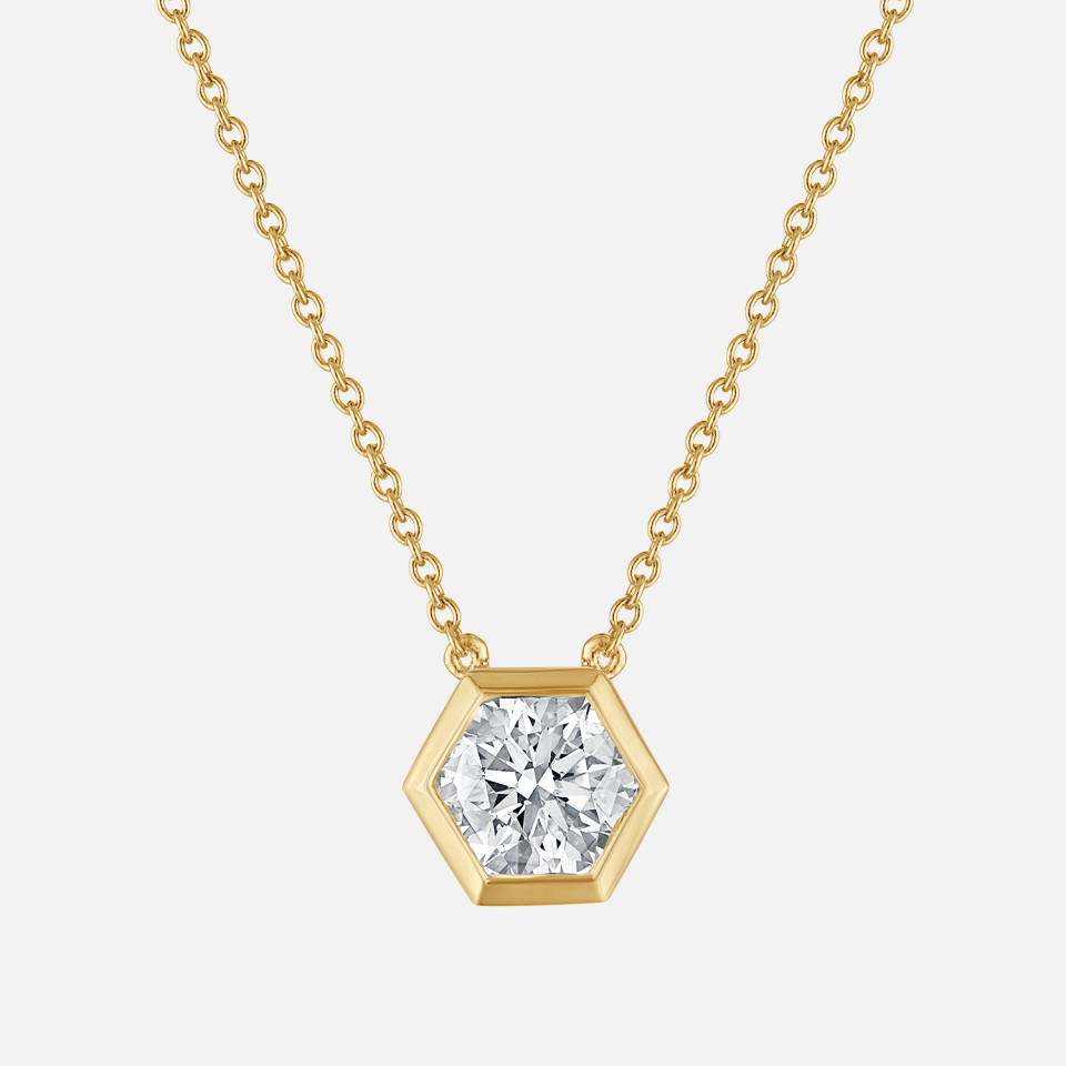 Refined bezel set hexagon shaped diamond pendant in yellow gold
