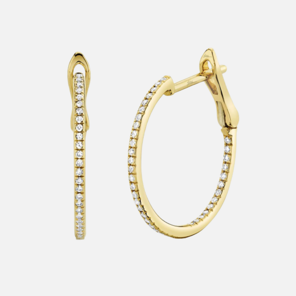 These diamond pavé hoops feature a total of 80 round diamonds along the earrings, set in 14k yellow gold.