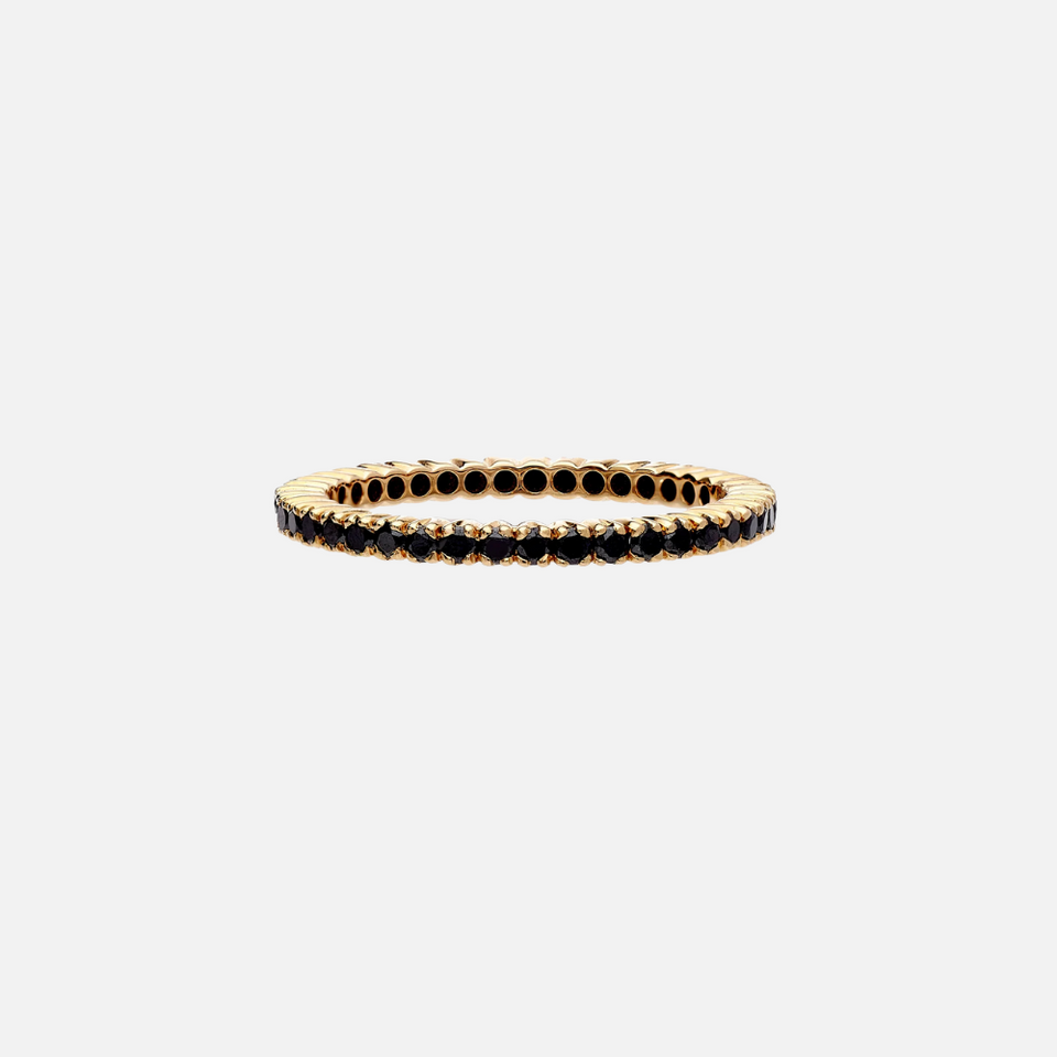 An 18k yellow gold eternity band set with 76 round diamonds in a prong setting.