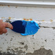 Filling a crack with a trowel knife using Blue Max® Trowel Grade Multi-purpose Waterproofer