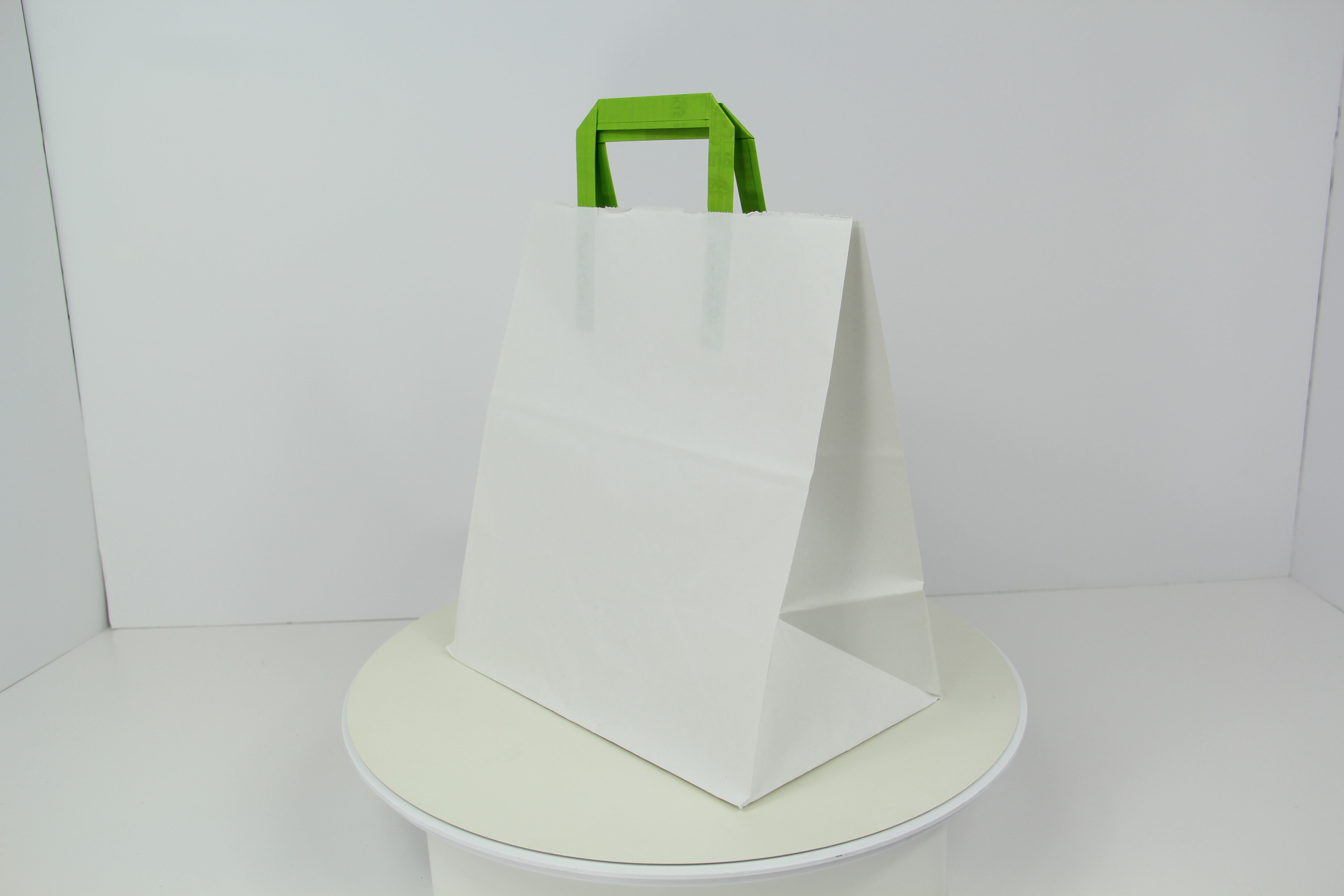 Paper shopping bag with cleaning household products on whi…