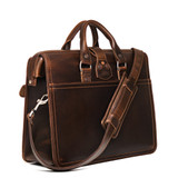 High quality backside of the flight bag leather briefcase showing the shoulder strap and two handles for easy carry. Made by Saddleback