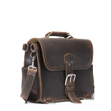 High quality side angle view of a dark brown rounded leather satchel.