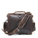 High quality back view with the strap of a dark brown rounded leather satchel.