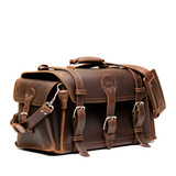 High quality dark brown side pocket duffle from the front. Made from full grain leather (toughest there is) and reinforced with rivets on any stress points. Made by Saddleback Leather