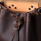 High quality closeup of the drawstring on the dark brown tumbled leather drawstring backpack. Made by Saddleback
