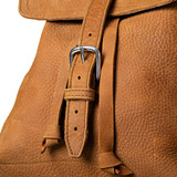 High quality close up of the buckle on the 12" drawstring backpack in tan tumbled leather. Made by Saddleback