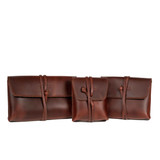 Set of three leather organizer bags in chestnut.