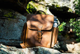 Leather backpack for hiking in tobacco/light tan leather.