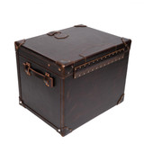 High quality back view of the dark brown colored leather small trunk that shows the craftsmanship of each stitch and a hinge that will last over 100 years. Made by Saddleback