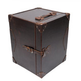 High quality dark brown colored leather small trunk standing upright showing off the well crafted handle and buckle. Made by Saddleback