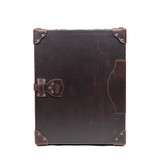 High quality front of the dark brown colored leather small trunk standing upright. Perfect for storing important documents or your comic book collection. Made by Saddleback