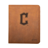 High quality tan colored leather portfolio with Cleveland Guardians logo on the front, made by Saddleback