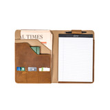 High quality inside of the tan colored leather portfolio that is holding a notepad, newspaper, journal, a pen, and cards. Made by Saddleback