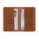 High quality inside of the tan colored leather business card holder that has 2 pockets with credit cards and business cards in it. Made by Saddleback