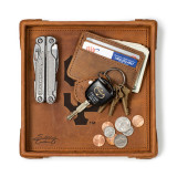 High quality tan colored leather valet tray that has a wallet, keys, change, and a pocket knife on it. Made by Saddleback