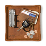 High quality tan colored leather valet tray holding a wallet, keys, change, and pocket knife. Made by Saddleback