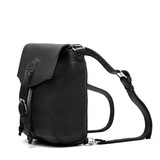 High quality the side profile of the 10" tumbled drawstring leather backpack in the color black. Made by Saddleback