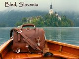 This is a red brown full grain leather briefcase on a rowboat in Bled Slovenia.