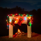 Here we have a fireplace with Christmas lights strung above and 3 stockings hung from the mantle. Made by Saddleback