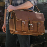High quality man holding the brown leather briefcase as a laptop bag.
