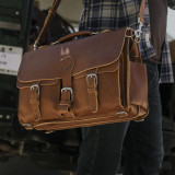 High quality brown leather briefcase with a front view on the hip.