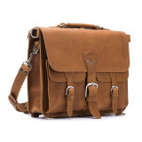High quality front side of a light tan brown leather briefcase with front pockets and a buckle in the middle.