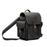 High quality black full grain leather baby tank backpack from the front. 2 side pockets and shoulder pads on the straps for extra comfort. Made by Saddleback