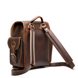 High quality dark brown full grain leather baby tank backpack from the back. Has 2 shoulder pads and a handle for easy carry. Made by Saddleback