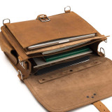 High quality light brown leather briefcase laying down with the flap open.