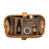 High quality tan brown leather toiletry bag on the opened and loaded.