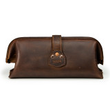 This is a red brown leather toiletry bag from the back.