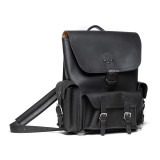 High quality black leather backpack with three pockets on the outside. The image of this backpack is the front side.