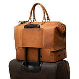 High quality view of the double compartment leather duffle in tan with luggage rack