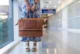 High quality lifestyle image of our tan compartment leather duffle