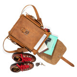 High quality tan brown leather backpack that is spilled out to see what fits.