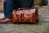 This is the lifestyle view of the Wesley Deep Pocket Duffle in  Italian Tan Leather