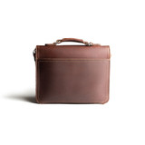 High quality back side of a red brown leather satchel with a front pocket.