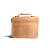 High quality back side of a tan brown leather satchel with a front pocket.