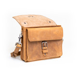 High quality front side of a tan brown leather satchel with a front pocket showing.