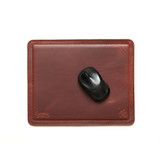 High quality red brown leather mouse pad with a mouse on it. It has stitching around the edges and neoprene in the middle.